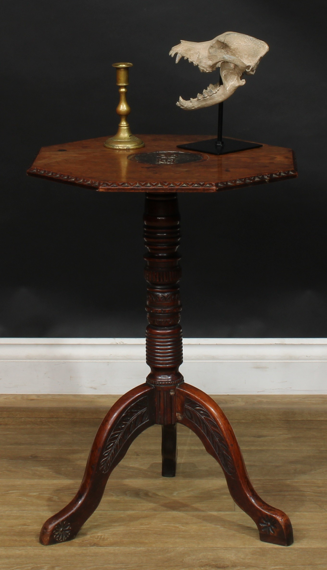 A 19th century oak tripod occasional table, possibly Masonic, octagonal top carved in relief with