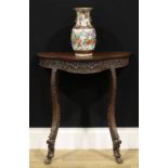 A 19th century Burmese hardwood serpentine console table, slightly oversailing top above a deep