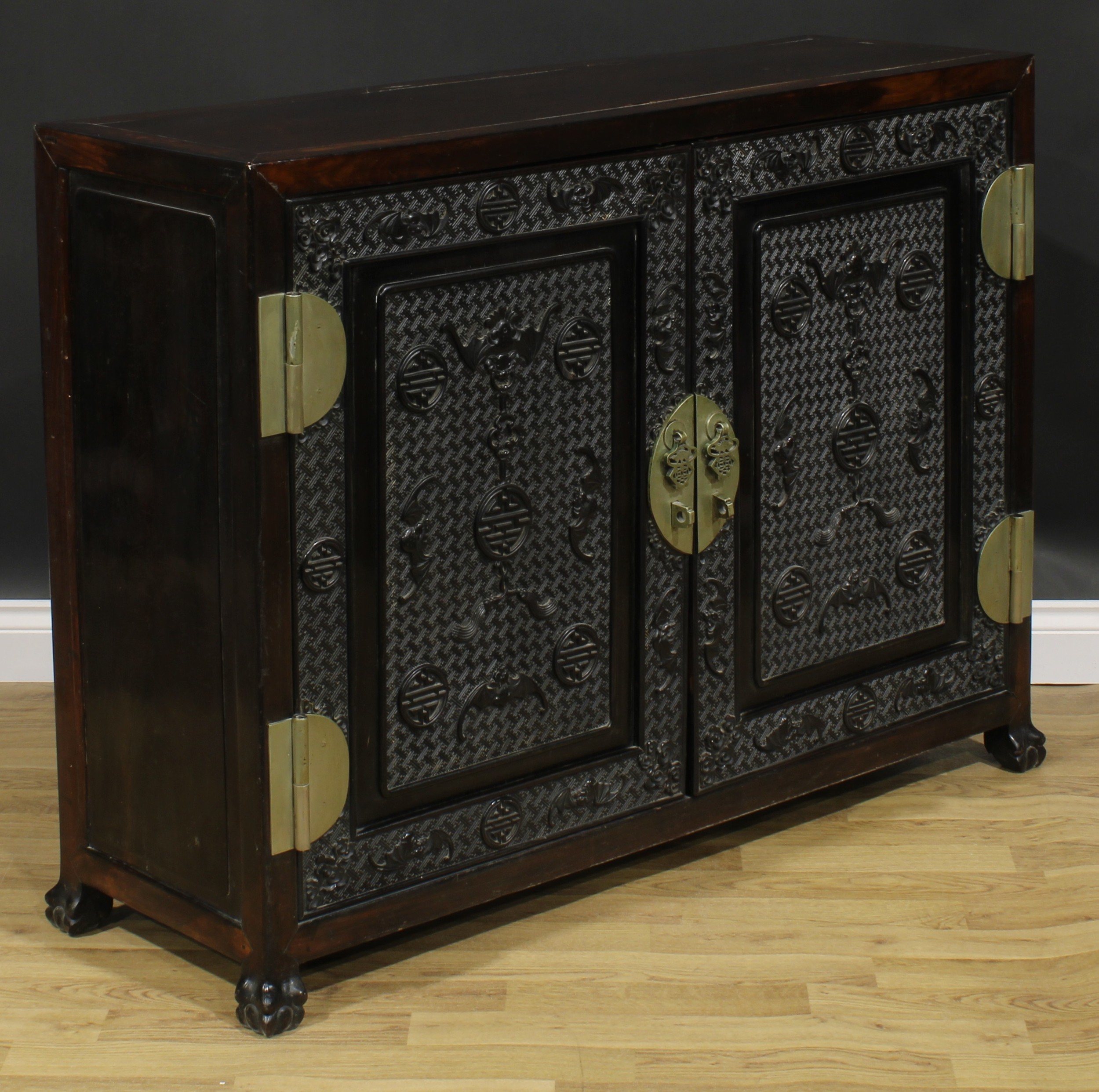 A Chinese hardwood side cabinet, rectangular top above a pair of panel doors carved and applied with - Image 4 of 6