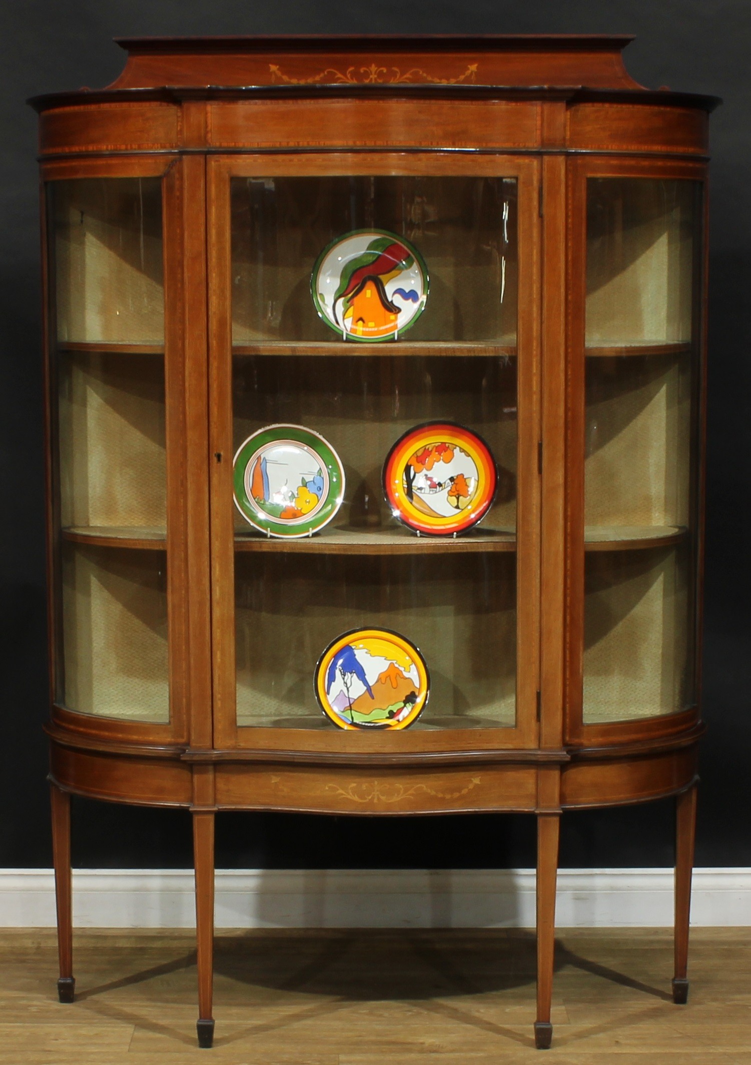 An Edwardian satinwood crossbanded mahogany and marquetry serpentine display cabinet, shaped