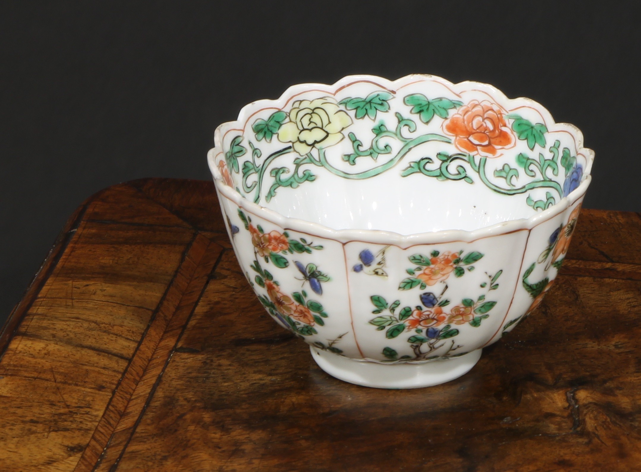 An 18th century Chinese shaped circular tea bowl or wine cup, painted in the famille verte palette