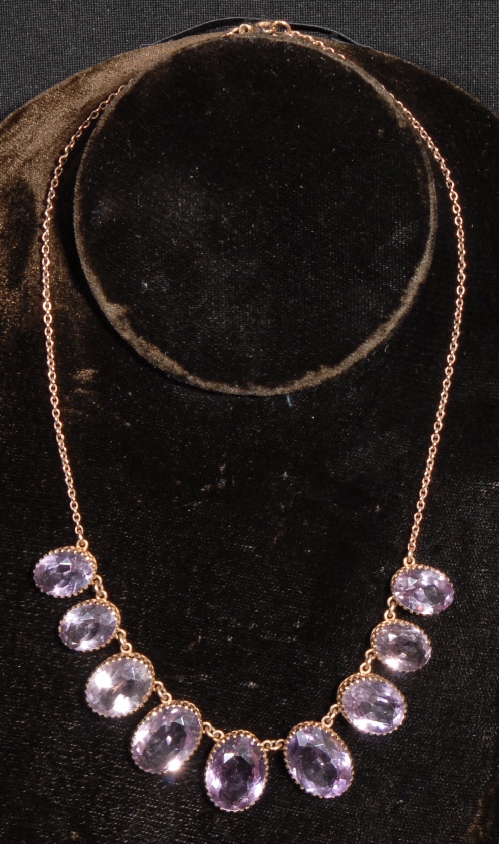 A 9ct rose gold and amethyst necklace and earring suite, the necklace set with nine graduated oval - Image 2 of 3