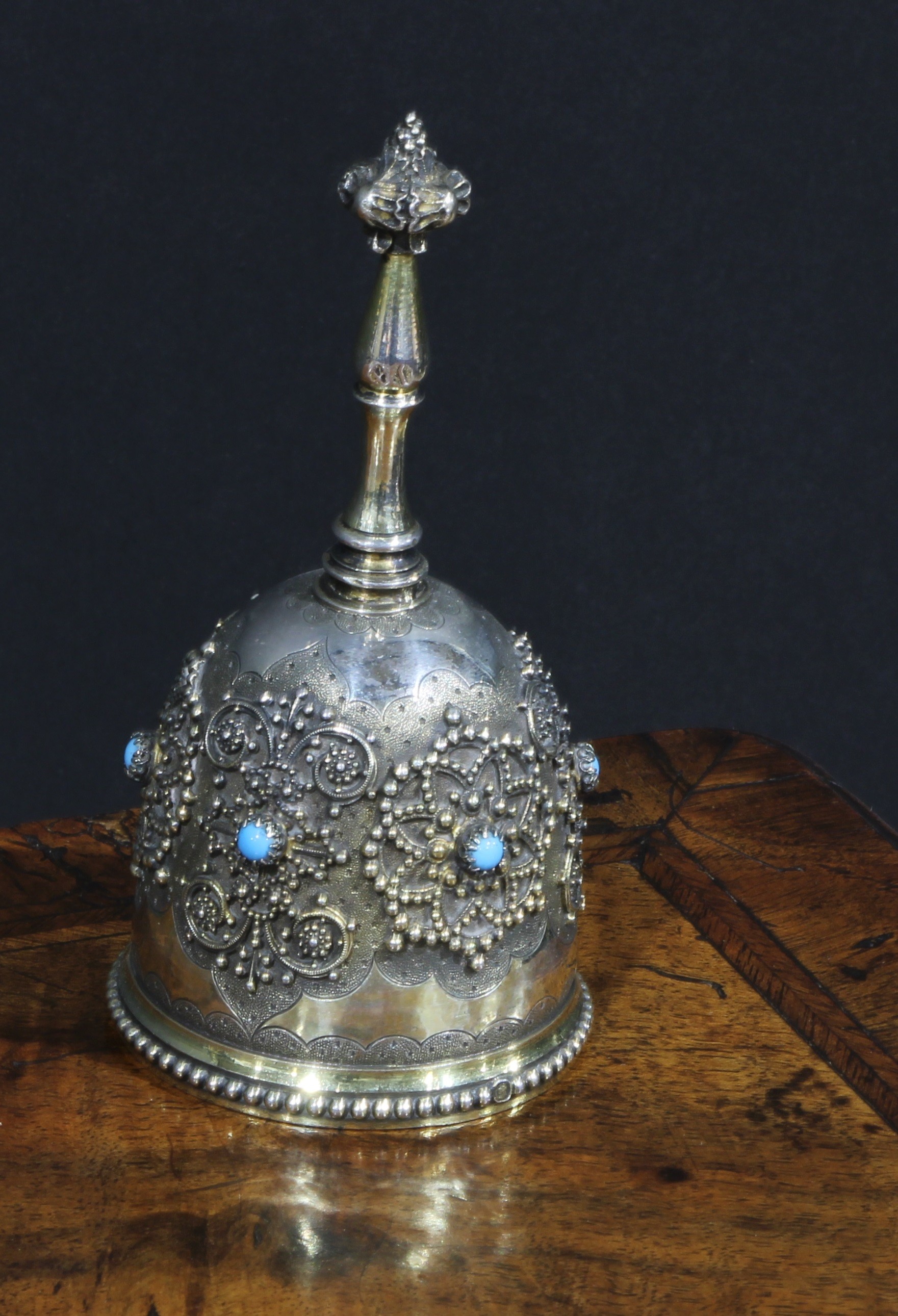 A 19th century French Renaissance Revival silver-gilt table bell, applied with medallions and set