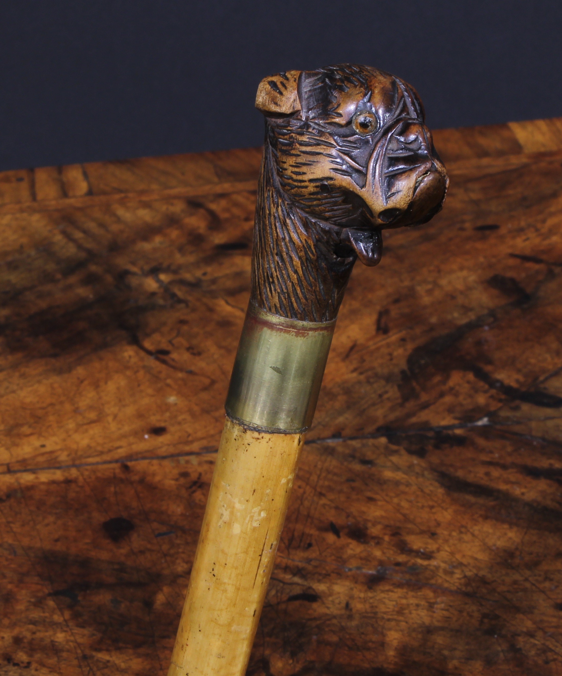 A late 19th century novelty automaton walking stick, the Black Forest type pommel carved as the head