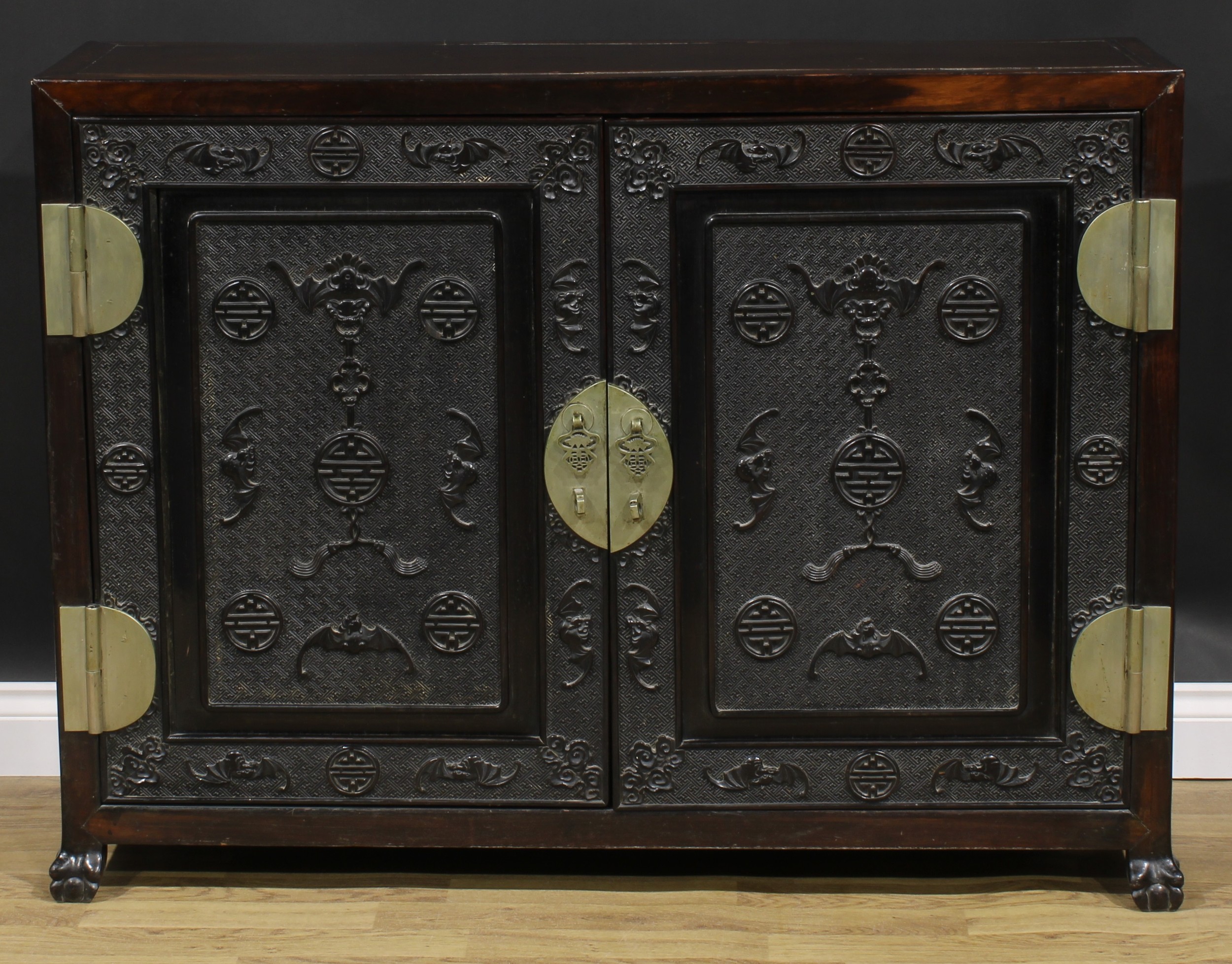 A Chinese hardwood side cabinet, rectangular top above a pair of panel doors carved and applied with - Image 2 of 6