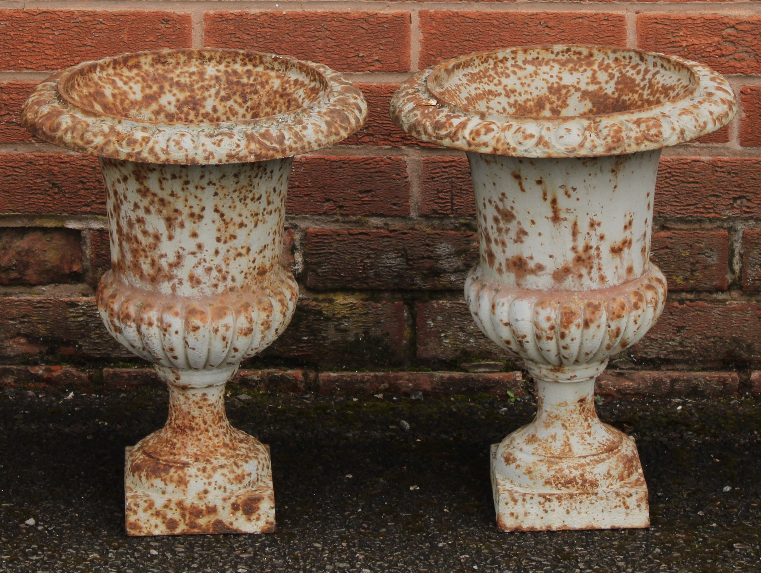 A pair of 19th century cast iron campana shaped garden urns, egg-and-dart rims, 43cm high, 33cm