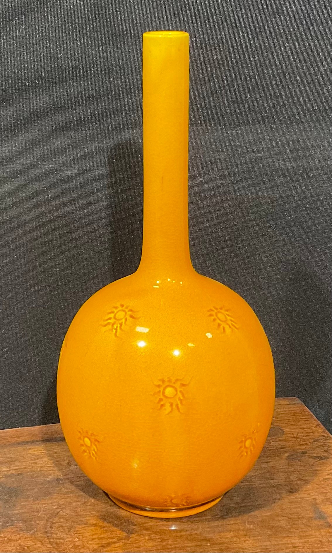 A Burmantofts Faience bottle vase, the globular body applied with sgraffito sunbursts, long