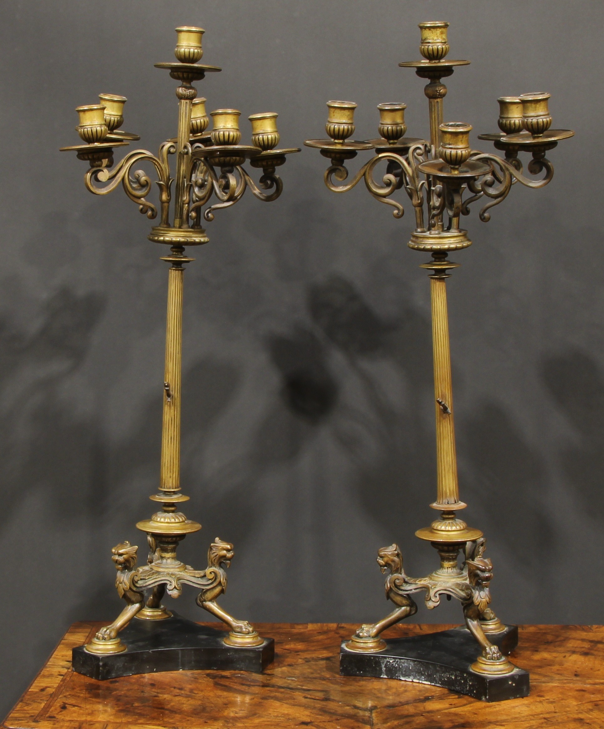 A pair of tall 19th century French bronze five-light candelabra, in the Grand Tour taste, half-
