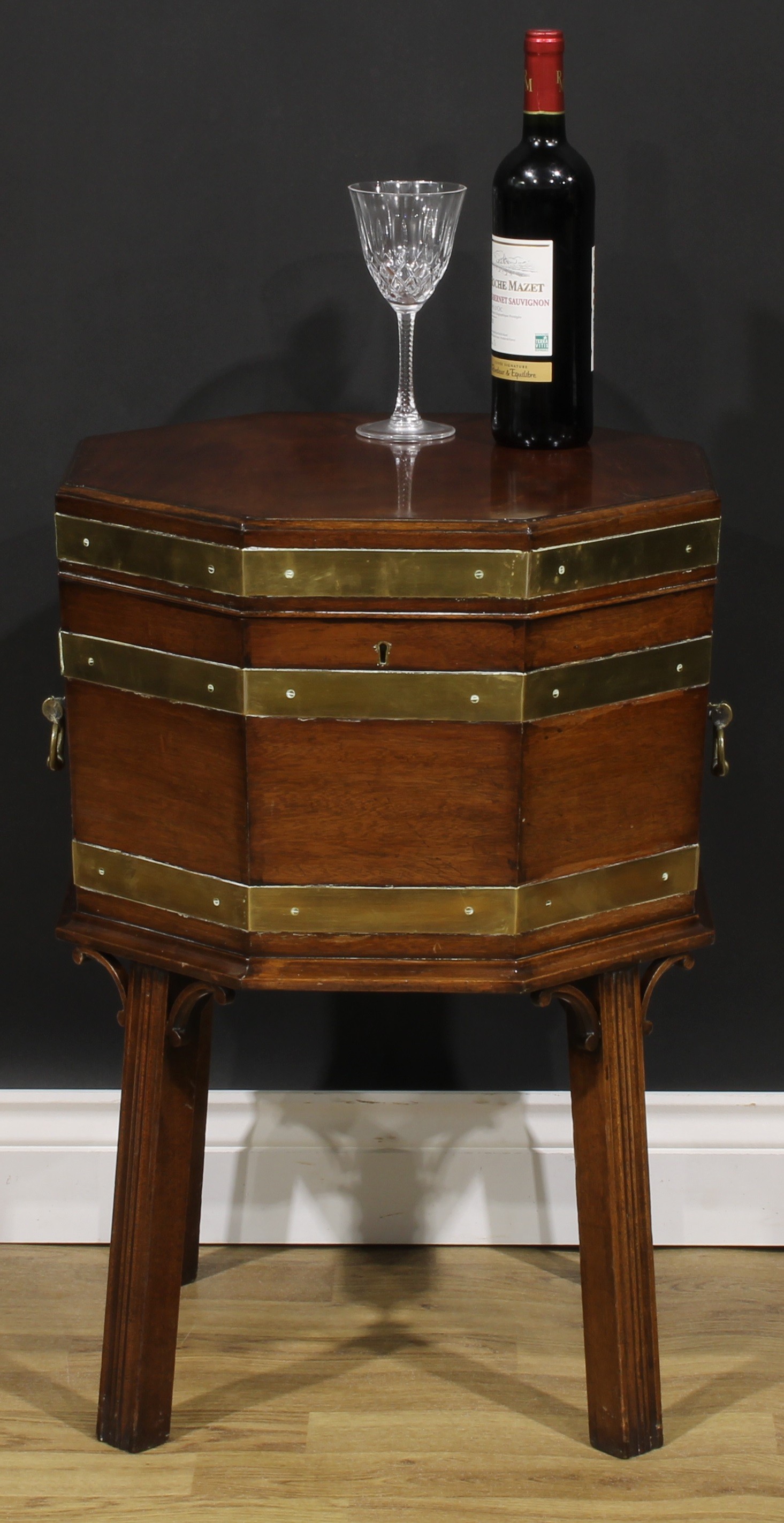 A George III Revival brass-bound mahogany octagonal cellarette or wine cooler, hinged top, removable