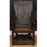 A 17th century and later oak wainscot chair, shaped rectangular back centred by a panel carved
