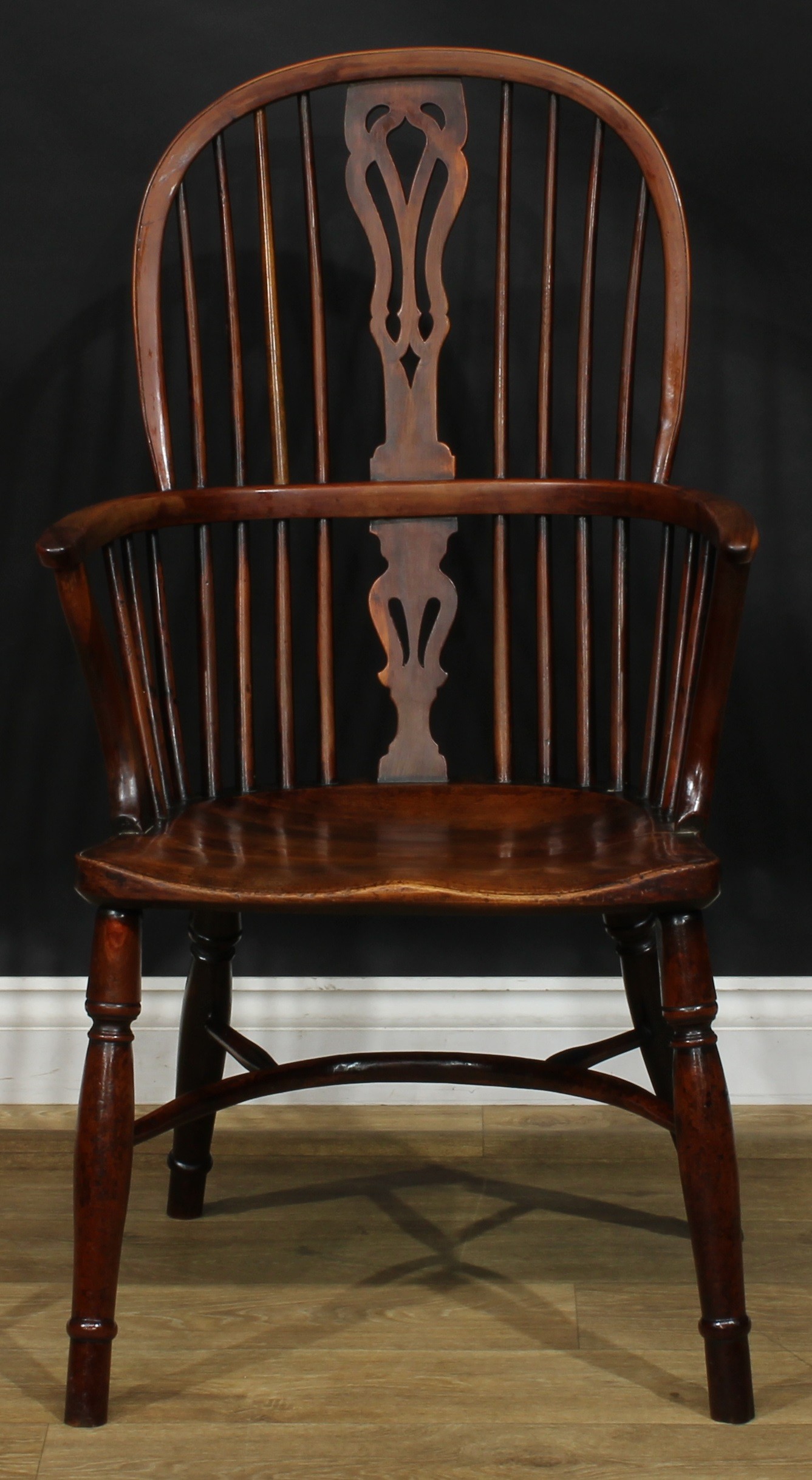 A 19th century yew and beech Windsor elbow chair, hoop back, shaped and pierced splat, one-piece