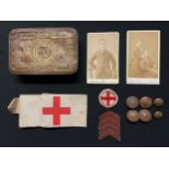 WW1 British Princess Mary's Gift Tin 1914 containing a Red Cross printed armband, Red Cross badge on