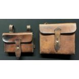 Pair of brown leather equipment pouches. Both are devoid of makers marks or dates. One sized 14.