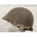 WW2 US M1 Helmet with swivel bale chinstrap. Rear seam. Heat stamp number 117B. Fitted with a