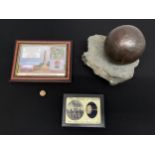 A cannon ball approx. 85mm in diameter of unknown origin on a rock display mount; An American