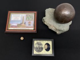 A cannon ball approx. 85mm in diameter of unknown origin on a rock display mount; An American