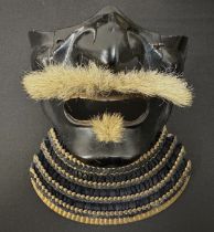 Japanese Samurai Menpo or Me no shita Facial Armour. Black laquered finish with gilt decoration