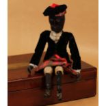 Folk Art - an early 20th century carved wooden and painted black doll, the carved and painted wooden