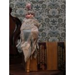 A German bisque shoulder head musical marotte doll, the bisque head with fixed blue glass eyes,