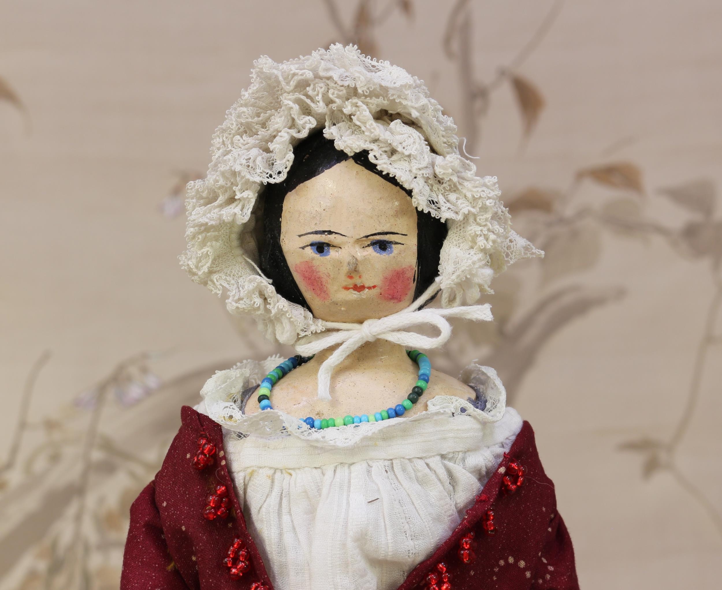 A mid 19th century carved and painted wooden doll, the carved and painted head with painted features - Image 2 of 2