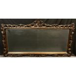 A large contemporary ornately carved hardwood wall mirror, bevelled glass, 101cm x 181.5cm (64cm x