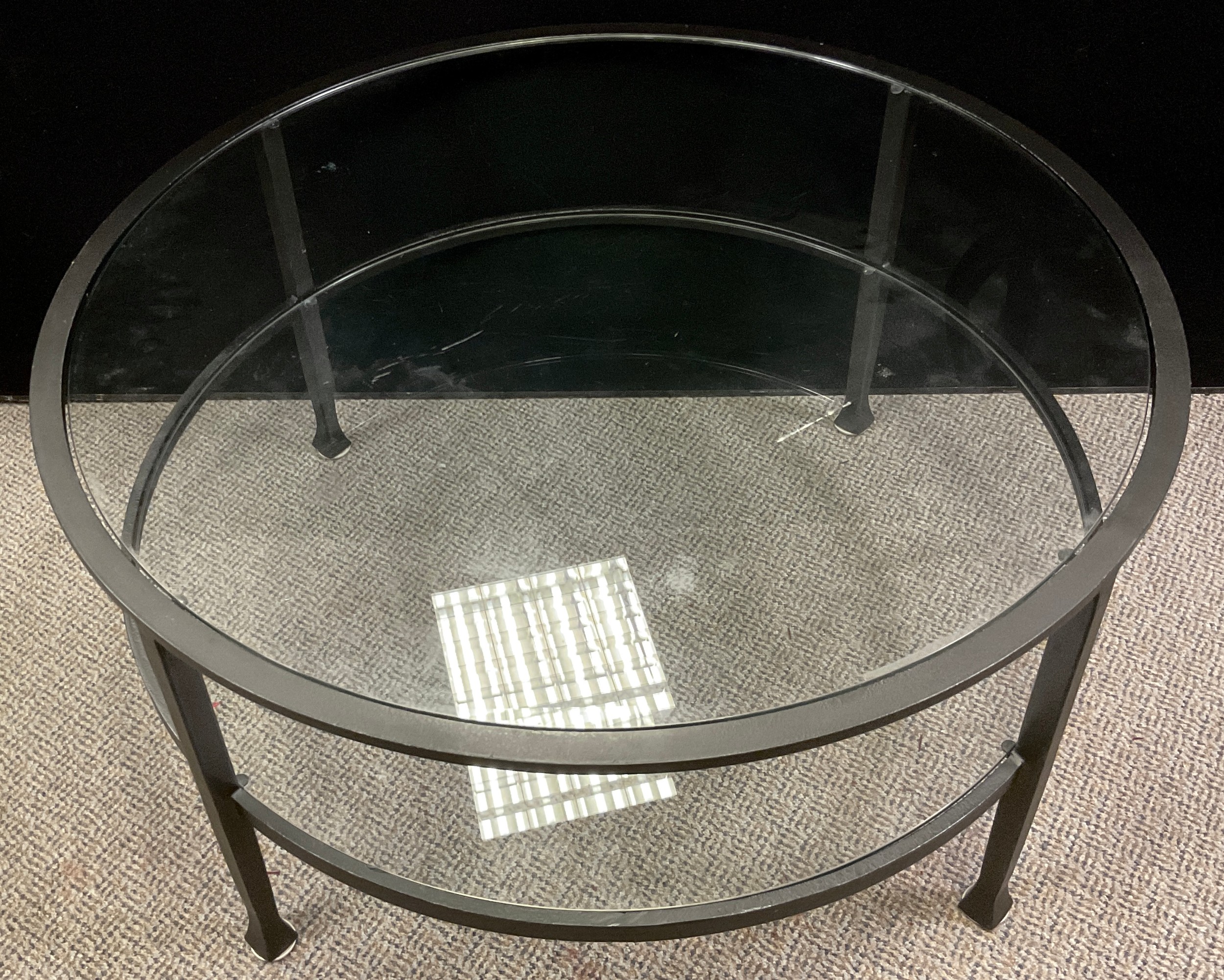 A contemporary metal and glass two tier coffee table, 47cm high x 91.5cm diameter.
