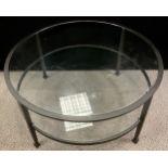 A contemporary metal and glass two tier coffee table, 47cm high x 91.5cm diameter.