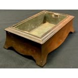 A 19th century mahogany rectangular table jardinière, the out swept sides with shaped apron and
