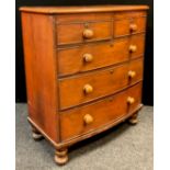 A Victorian mahogany bow-front chest of drawers, two short over three long graduated drawers, turned