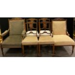 An Edwardian inlaid walnut part salon suite, comprised of Ladies and gentleman’s armchairs, and a
