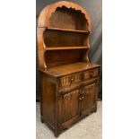 An ‘Old Charm’ style oak arch-top dresser, plate-rack top, above a pair of short drawers, and two