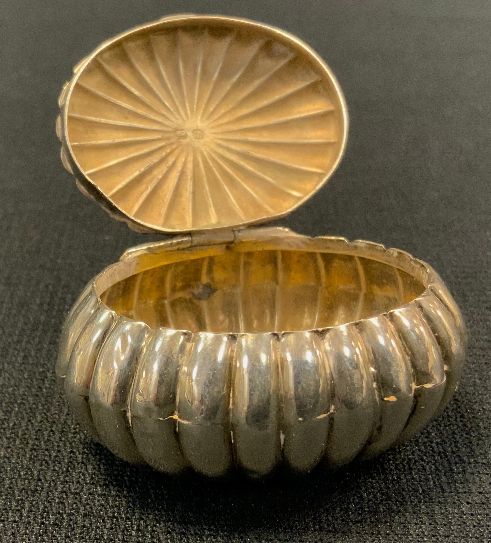 A silver ribbed ovoid snuff/pill box, suspension hoop, 4.5cm wide, Chester, 1895