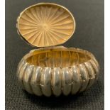 A silver ribbed ovoid snuff/pill box, suspension hoop, 4.5cm wide, Chester, 1895