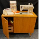 A Singer 760 Touch and Sew, vintage electric sewing machine, housed in a teak cabinet, 1970/80’s,