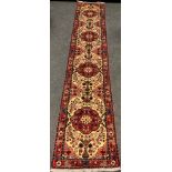 A North West Persian Rudbar runner carpet, hand-knotted with a row of four medallions within a field