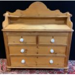A Victorian pine wash-stand chest of drawers, Saddle-shaped back-splash, two short over pair of long