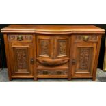An early 20th century walnut breakfront sideboard, having an arrangement of small drawers and