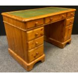 A Pine pedestal desk, by Ducal furniture, of Andover, rounded rectangular top with inset green