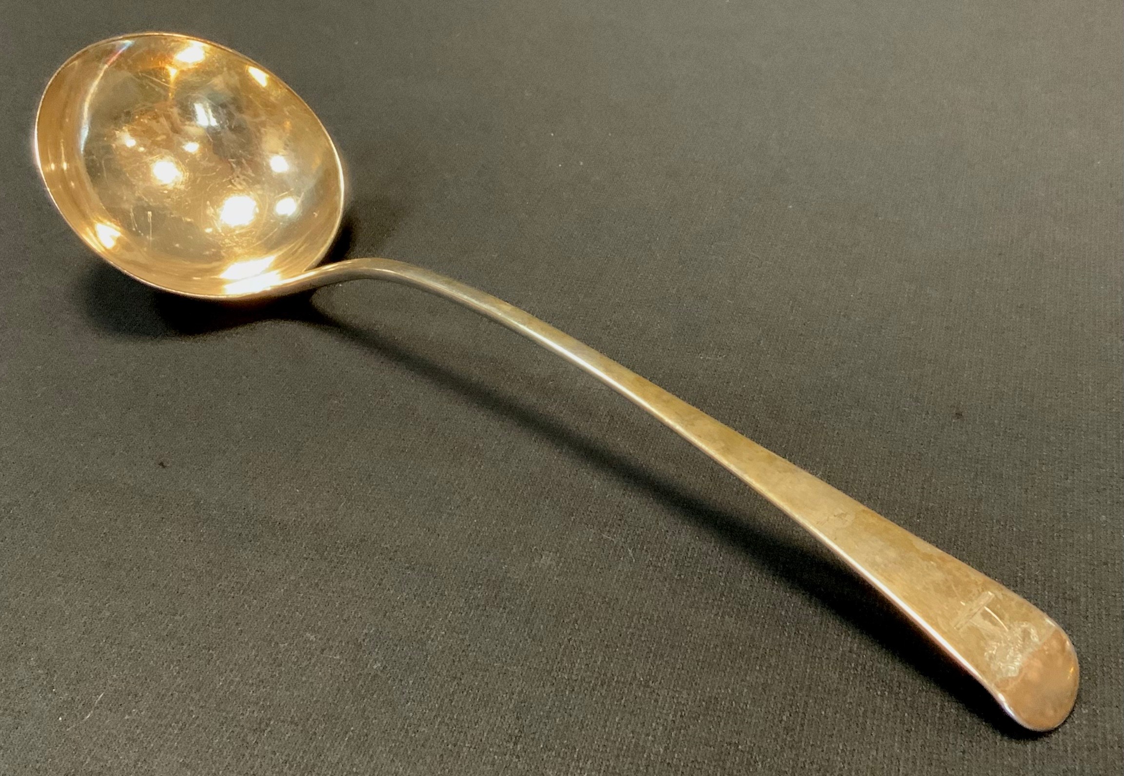 A George III silver soup ladle, the handle engraved with a Fist grasping a Scorpion, Thomas Wallis