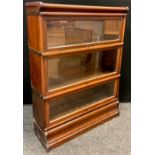 A Globe Wernicke mahogany three tier sectional bookcase, glazed lift-up door to each section, 112.