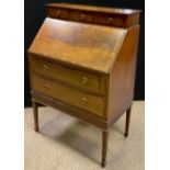 An Edwardian walnut bureau, three small drawers to top, over a fall door enclosing a fitted