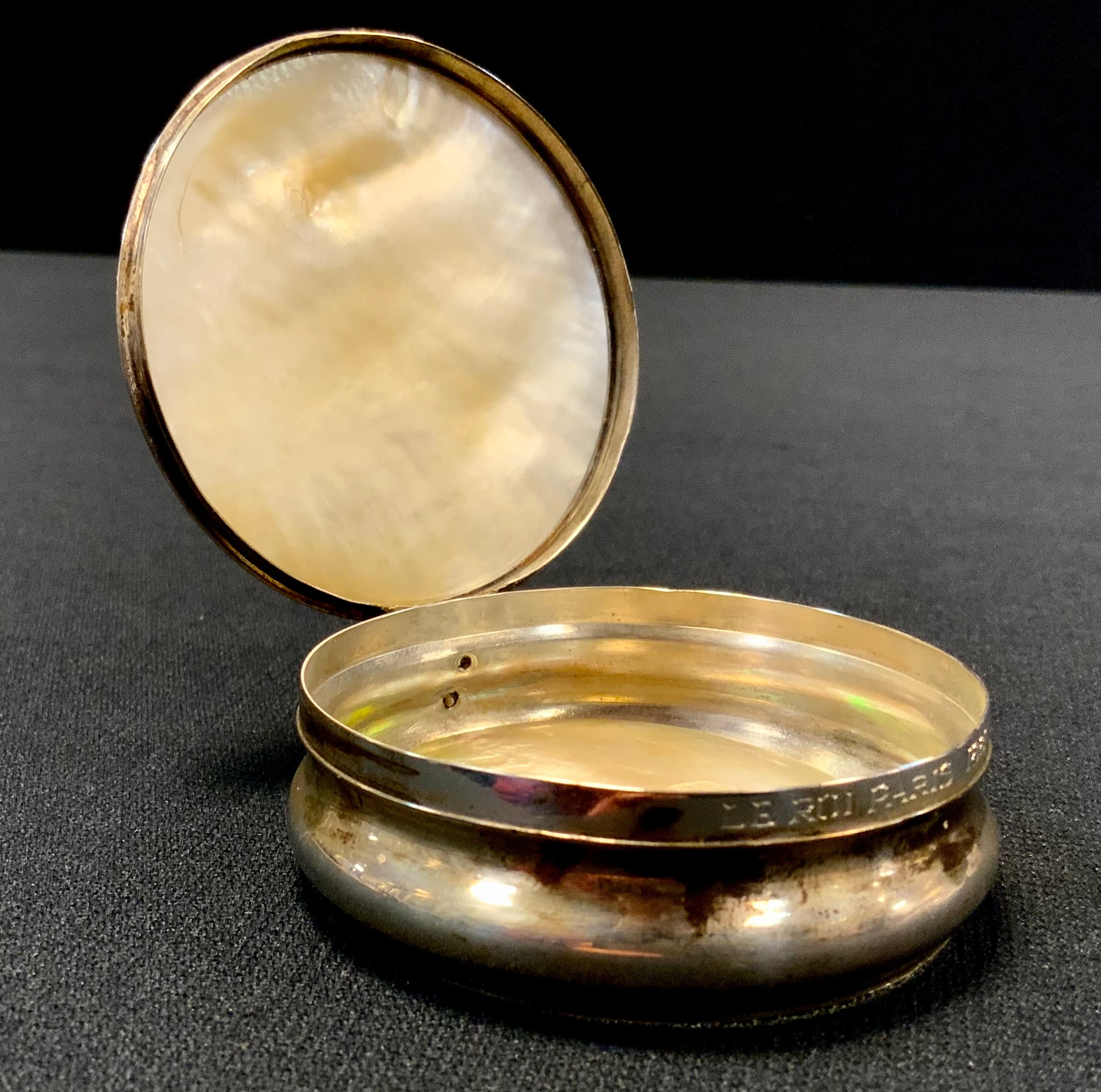 A silver coloured metal and mother of pearl snuff box, the hinged cover carved, the sleeping man