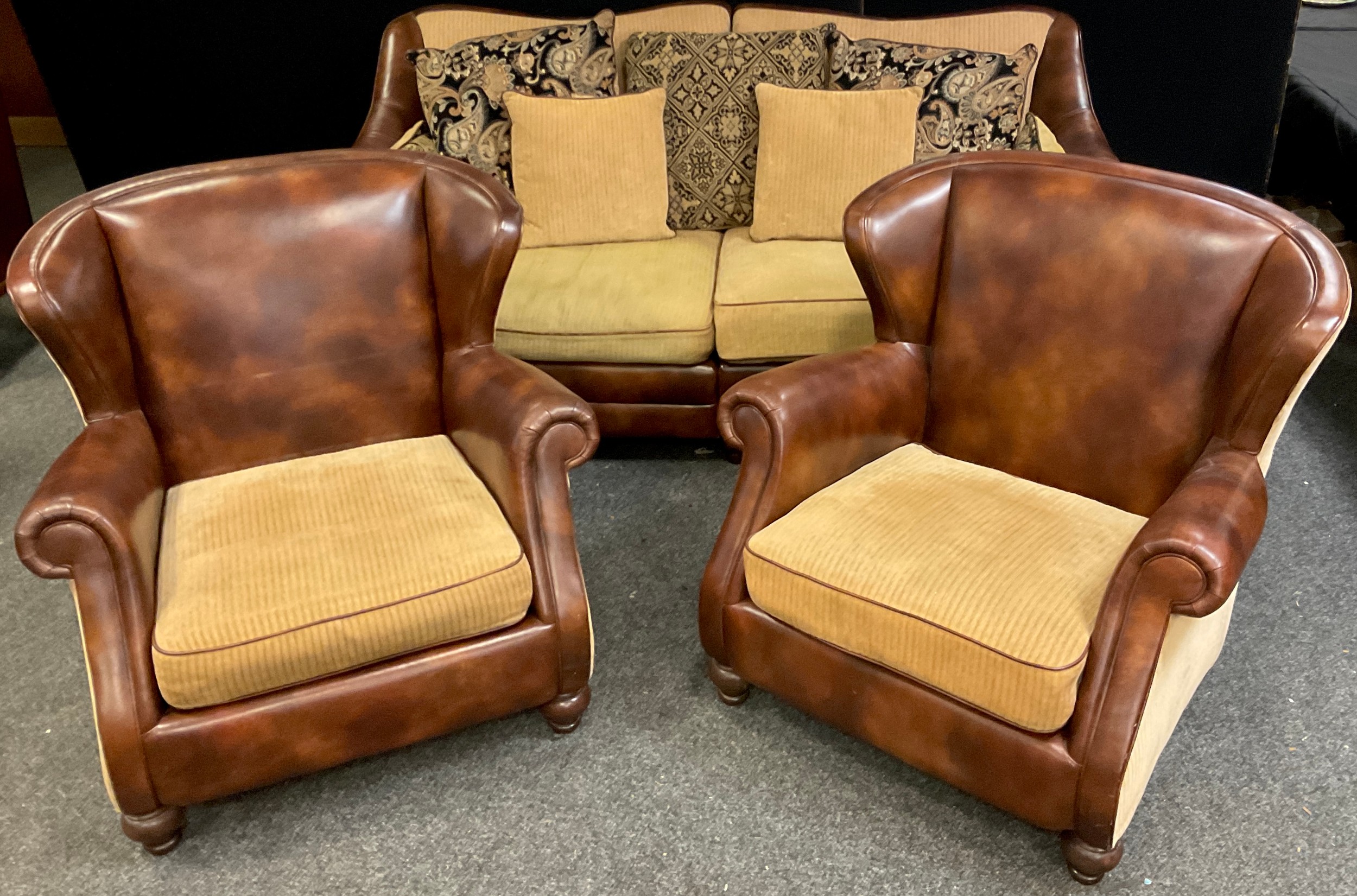 A Contemporary three seat tan leather and fabric sofa, and pair of matching armchairs, sofa