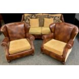 A Contemporary three seat tan leather and fabric sofa, and pair of matching armchairs, sofa