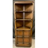 An Ercol elm floor standing corner cupboard / shelving unit, 184cm high x 71cm wide.