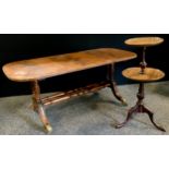 A George III style mahogany two tier wine table, slightly dished tiers, turned urnular column,