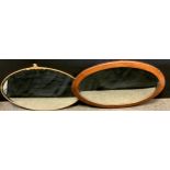 An oval mahogany wall mirror, bevelled plate, 82cm x 57cm overall; another gilt framed (2)