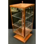A small copper lantern head display cabinet, polished case and shaped base, tubular pole support,