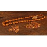 An amber coloured resin bead necklace, composed of thirty nine graduated butterscotch beads, 34cm