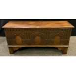 A mid 20th century reproduction narrow oak coffer / blanket chest, carved front panel, bracket feet,